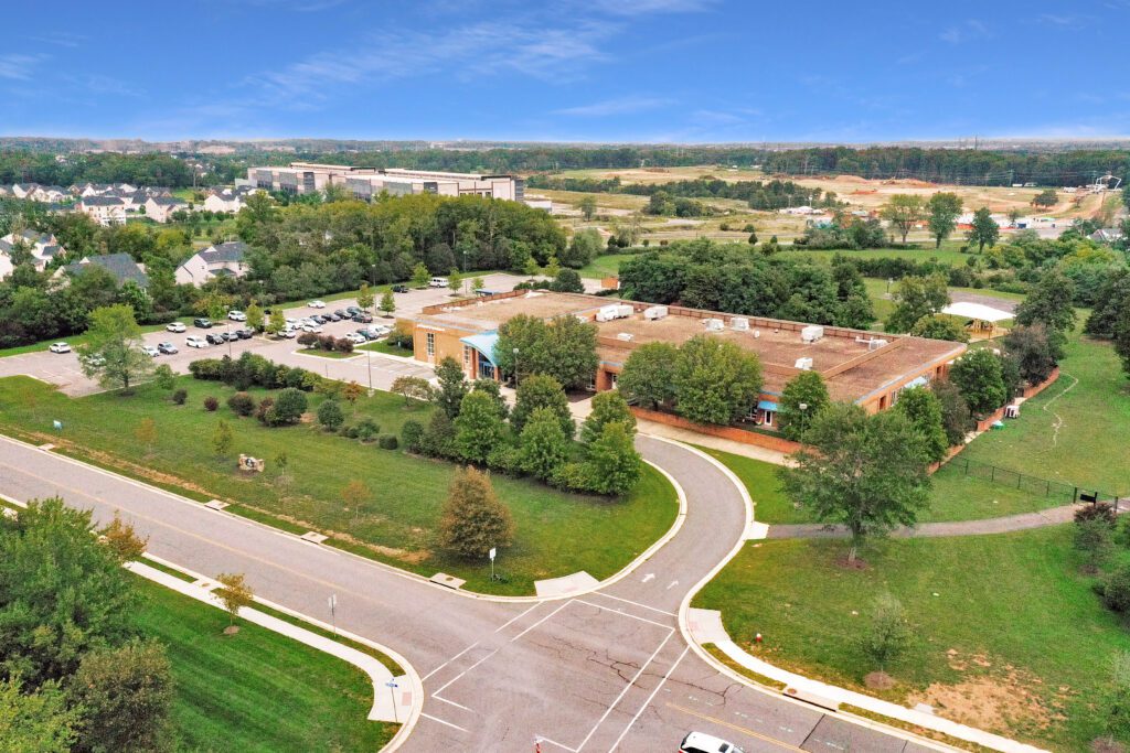 Aerial drone view of the commercial property at 24328 Marrwood Drive, Aldie, VA, showcasing its expansive single-story building and 14.63-acre lot.